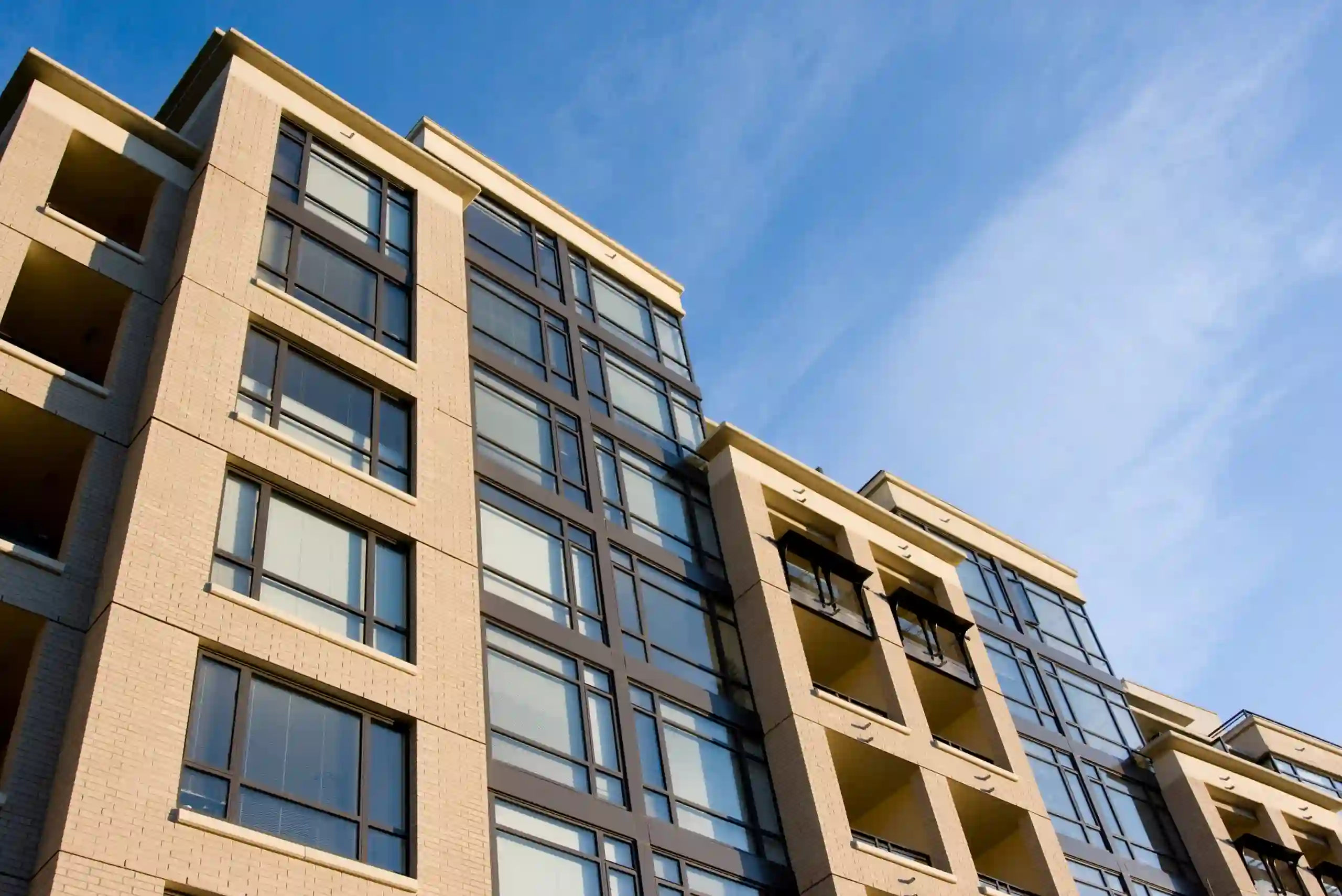 Multi-unit building exterior with windows and recessed balconies.